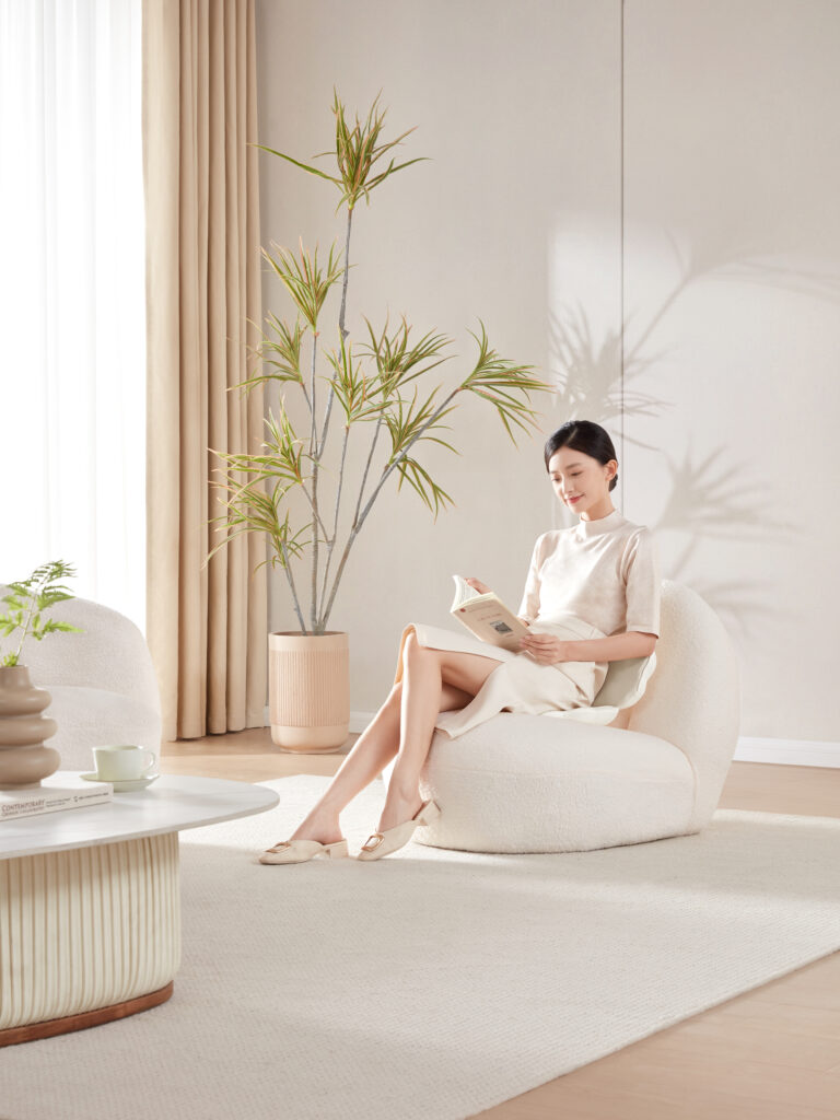 a woman sitting in a chair reading a book